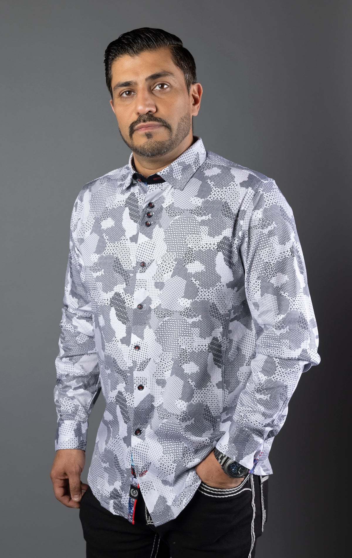 Long sleeve shirt with a stretch material in a variety of colors. The shirt has three buttons grouped together at the top placket, multiple embroidery details, and elegant ceramic buttons on the sleeve placket.