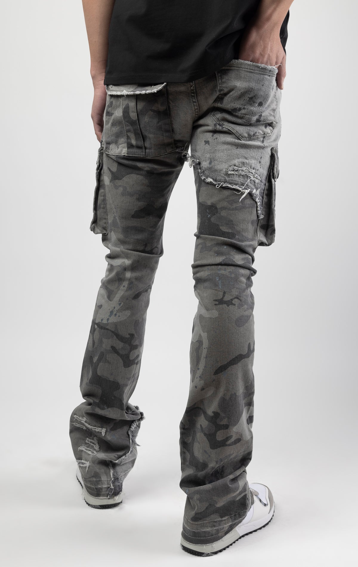 Overcast camo extended length flare pant with a regular rise for maximum stacks. Skinny fit with hand-smearing and speckled paint splatter throughout. Rip and repair detailing, accompanied by cut & sewn woodland camouflage twill patches. Stitching repairs and deep front pocket bags, perfect for large smart phones.