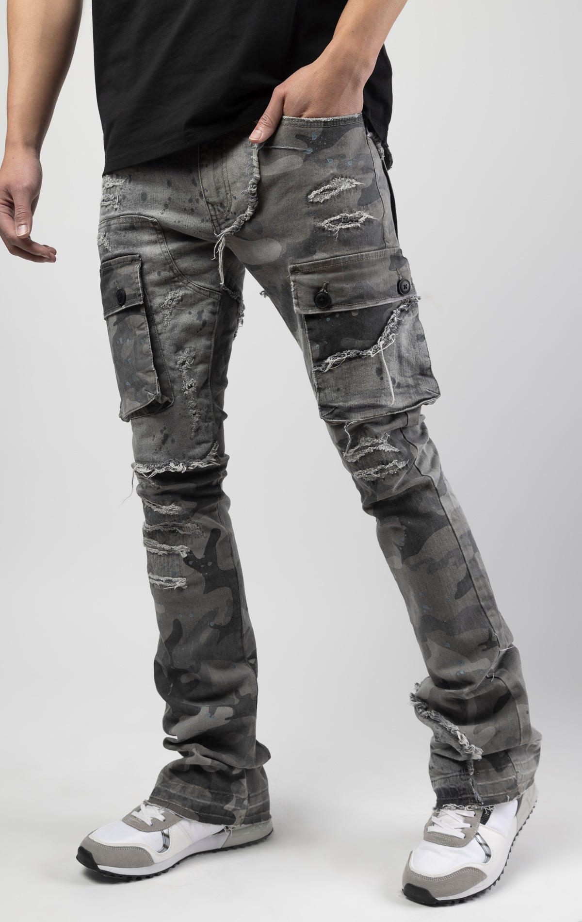 Overcast camo extended length flare pant with a regular rise for maximum stacks. Skinny fit with hand-smearing and speckled paint splatter throughout. Rip and repair detailing, accompanied by cut & sewn woodland camouflage twill patches. Stitching repairs and deep front pocket bags, perfect for large smart phones.