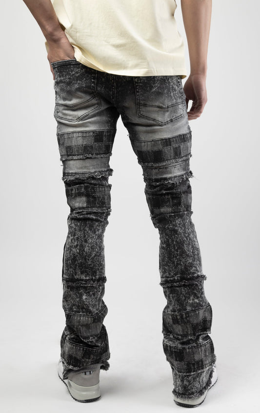 Black wash iconic stacked jeans crafted from high-quality, durable denim fabric consisting of 98% cotton and 2% spandex with a semi flare silhouette and a length of 35"-37". Featuring a distinctive ripped and repair design with pocket patches and a multi-tone dye throughout, these urban-inspired pants are true to size