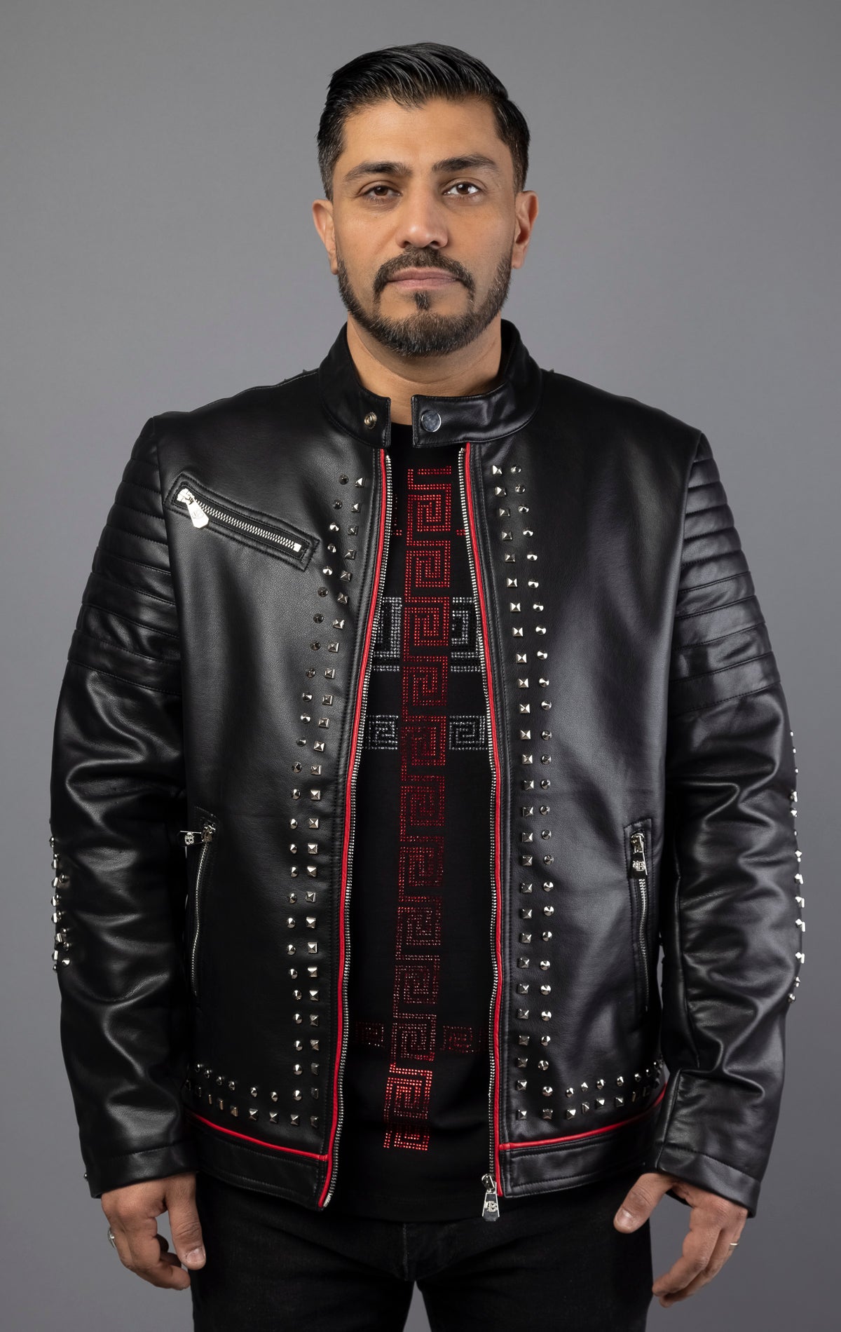 This leather jacket features red piping and intricate embroidery patches, as well as top-quality silver studs. Made with soft, genuine cowhide leather, this rock punk style jacket includes two side pockets. Color: black.