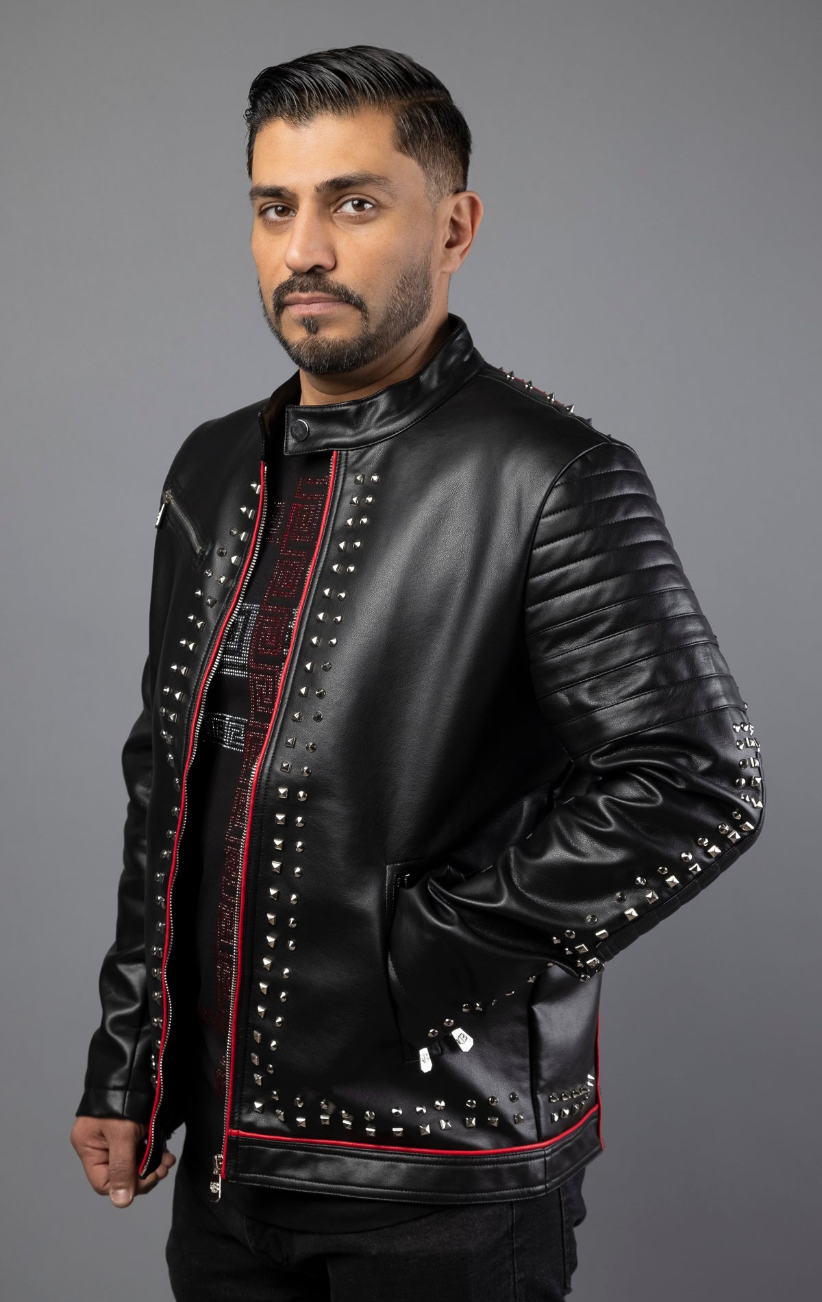 This leather jacket features red piping and intricate embroidery patches, as well as top-quality silver studs. Made with soft, genuine cowhide leather, this rock punk style jacket includes two side pockets. Color: black.