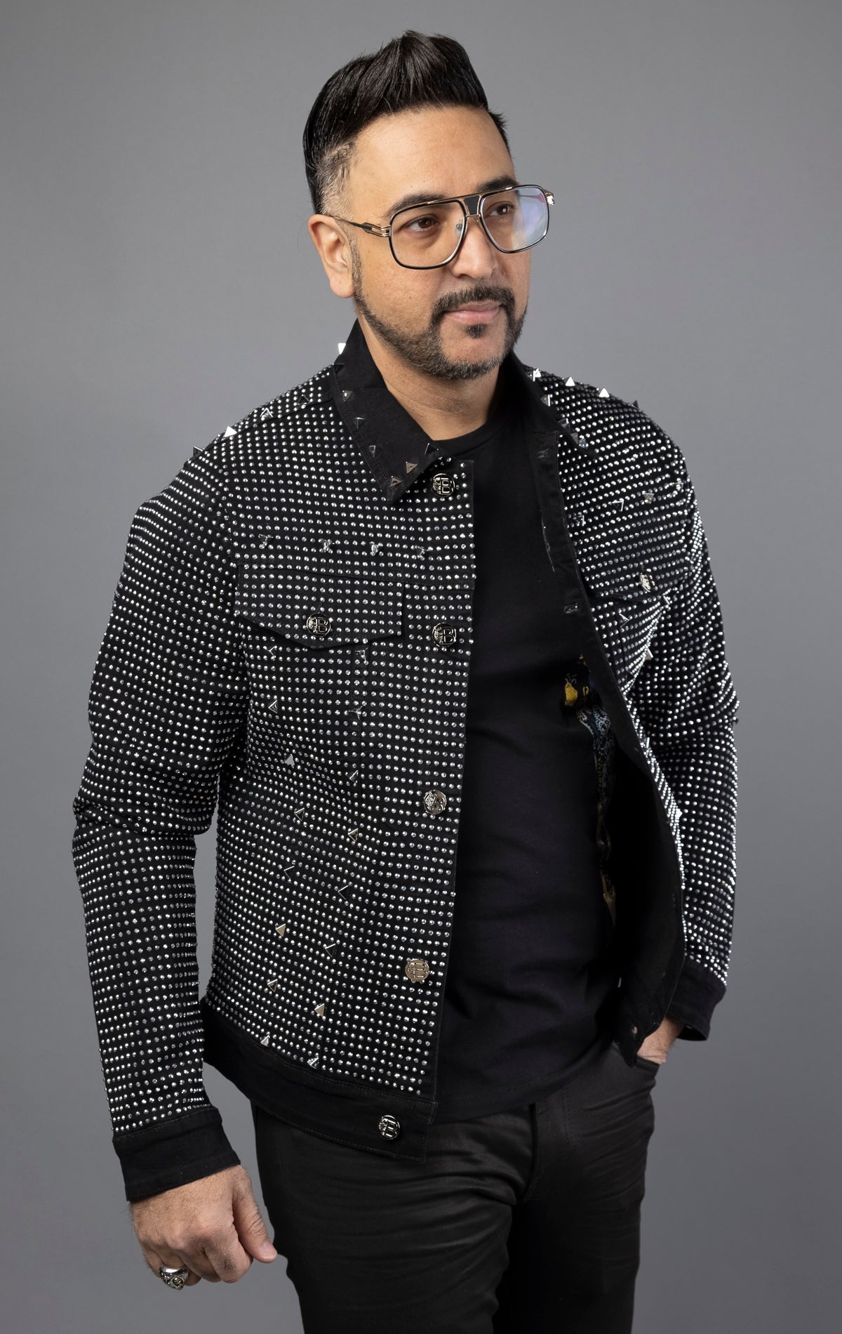 Black stylish jean jacket adorned with crystals and spikes for men.