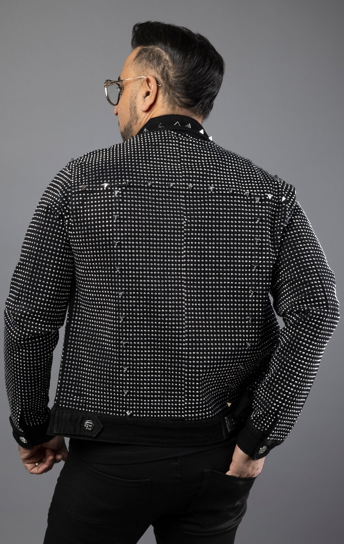 Black stylish jean jacket adorned with crystals and spikes for men.