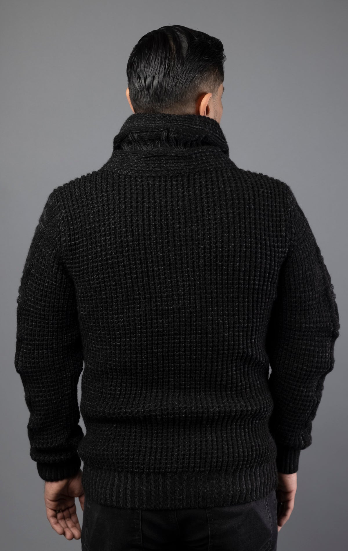 Man wearing heavy-weight, high quality sweater in black color. Designed with a slightly slim fit