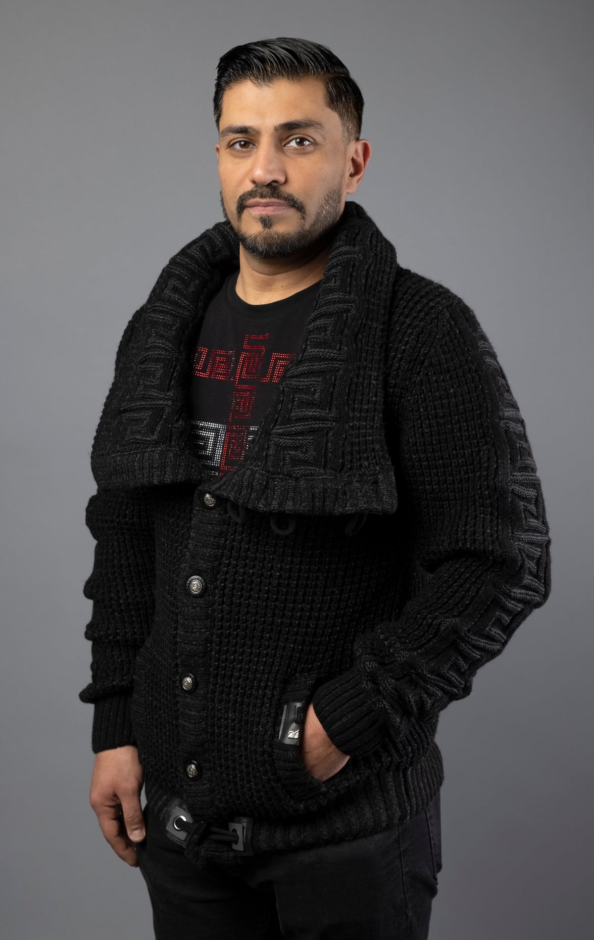Man wearing heavy-weight, high quality sweater in black color. Designed with a slightly slim fit