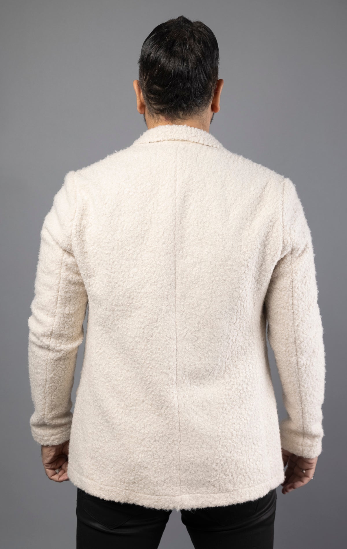 Beige overshirt boasts a faux teddy material and oversized fit, complete with a soft lining, and chest pockets.