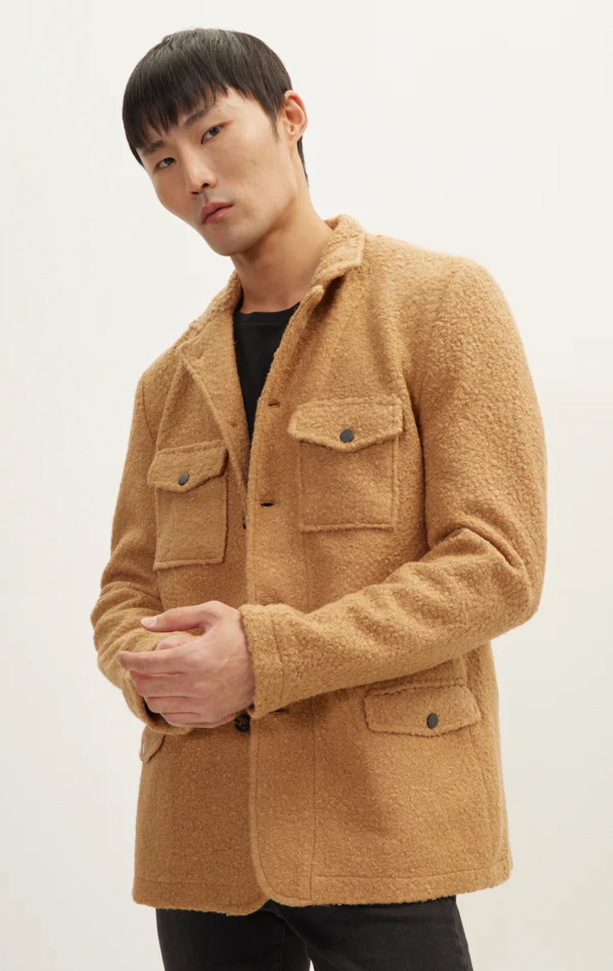Camel overshirt boasts a faux teddy material and oversized fit, complete with a soft lining, and chest pockets.