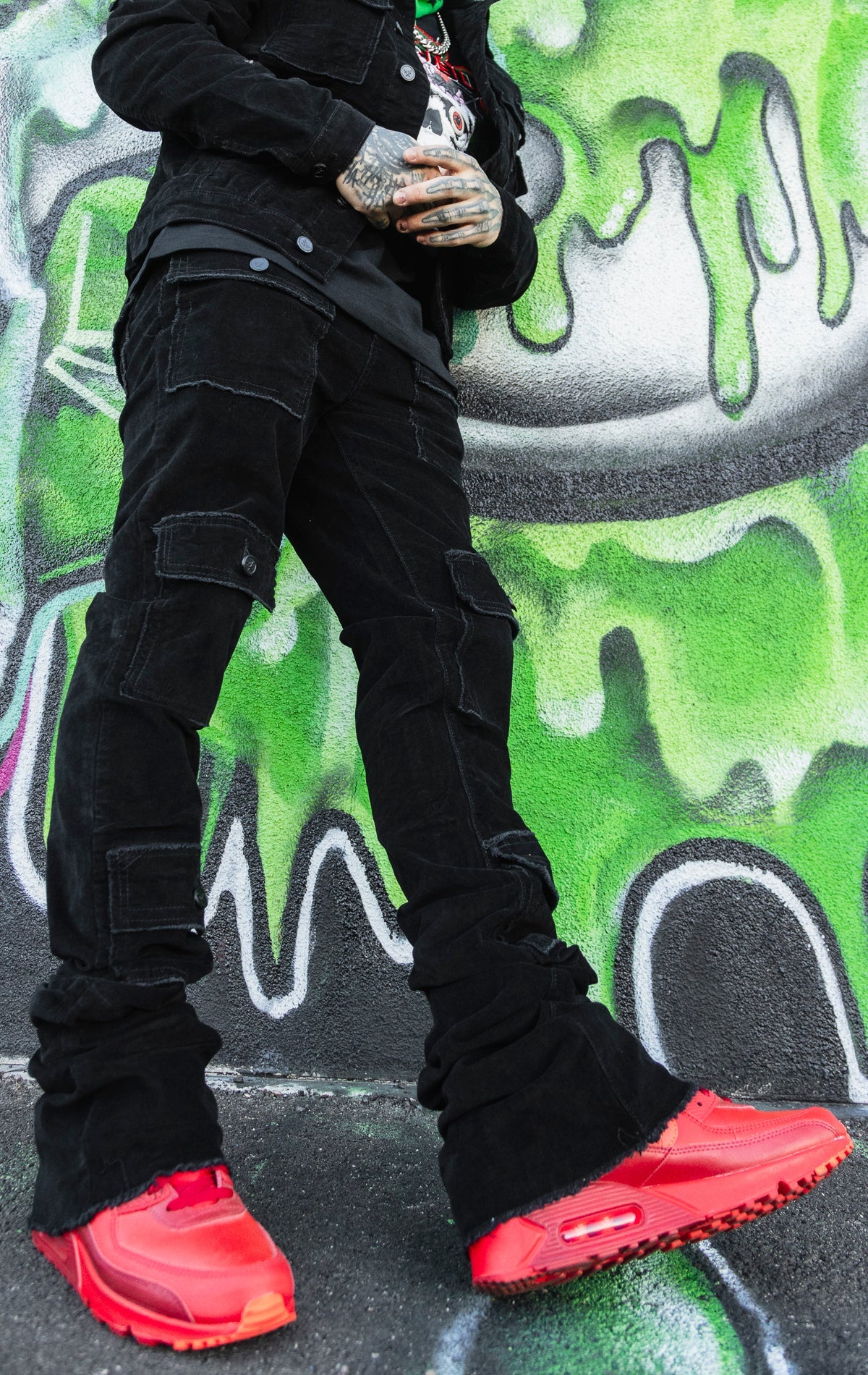 Stacked corduroy cargo jeans in black.