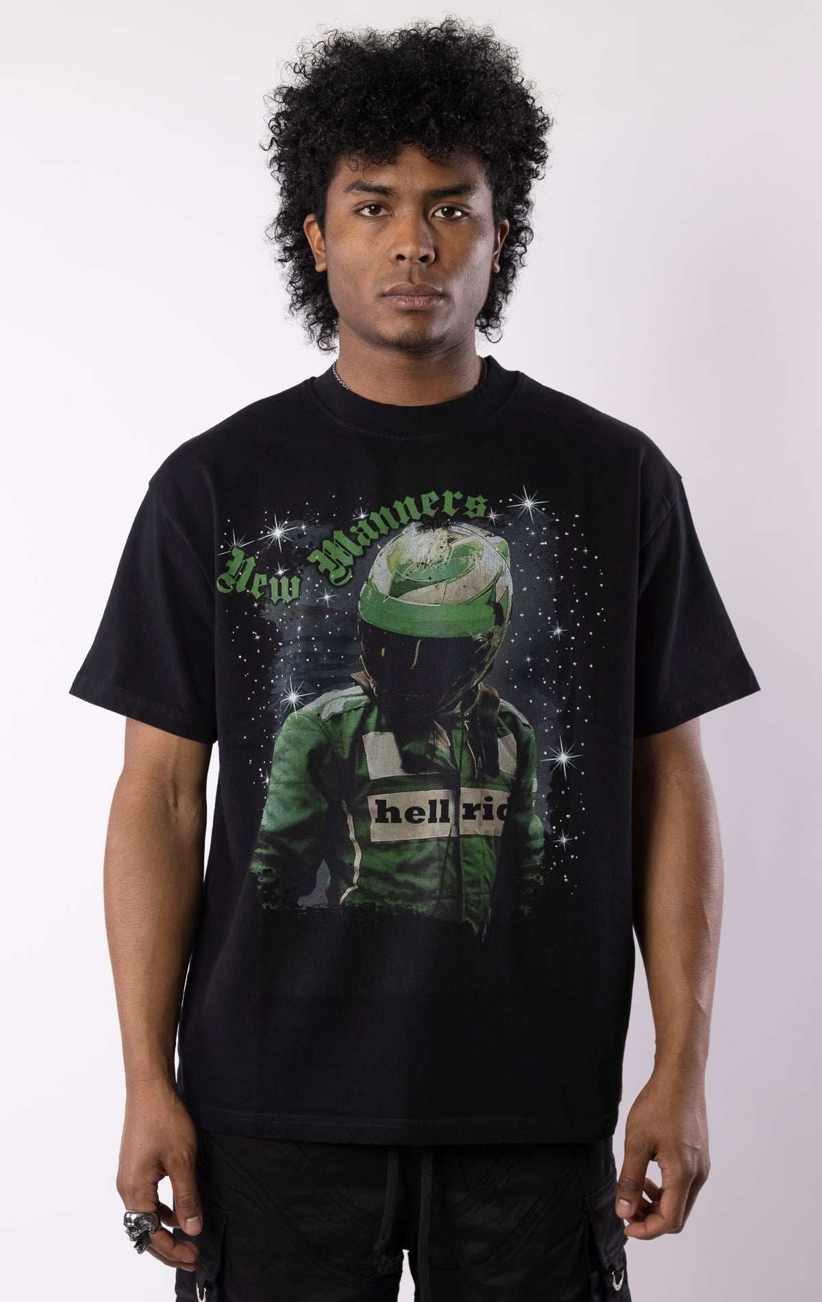 Black t-shirt with a bold graphic of a race-suited rider under a starry night sky, gothic lettering, and a relaxed crewneck fit.
