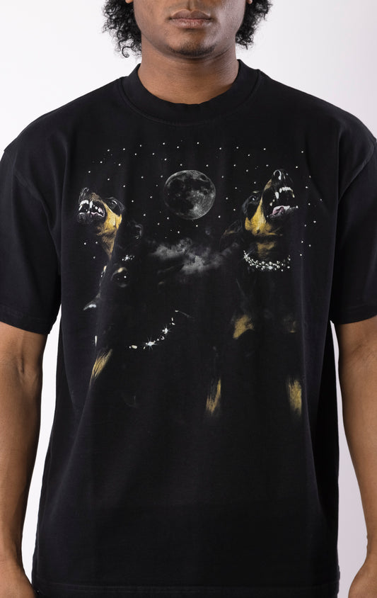 Black t-shirt with snarling dogs graphic under a moon and stars, featuring a bold print on the front and a relaxed crewneck fit.
