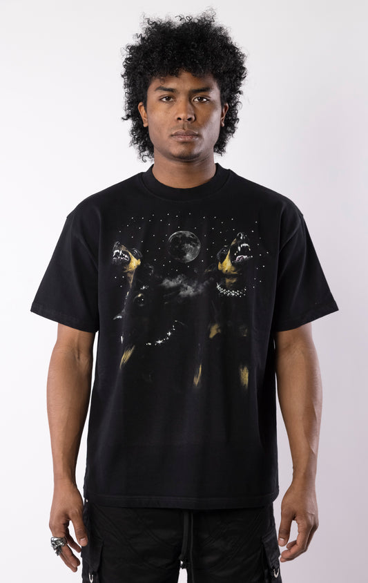 Black t-shirt with snarling dogs graphic under a moon and stars, featuring a bold print on the front and a relaxed crewneck fit.