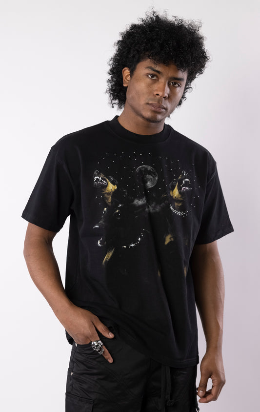 Black t-shirt with snarling dogs graphic under a moon and stars, featuring a bold print on the front and a relaxed crewneck fit.