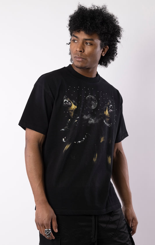 Black t-shirt with snarling dogs graphic under a moon and stars, featuring a bold print on the front and a relaxed crewneck fit.