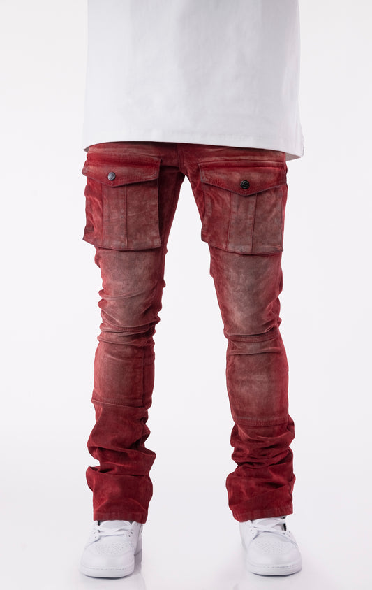Red velour-coated stacked jeans with oversized cargo pockets, showcasing a soft texture, button closures, and extended length for a stacked ankle look.