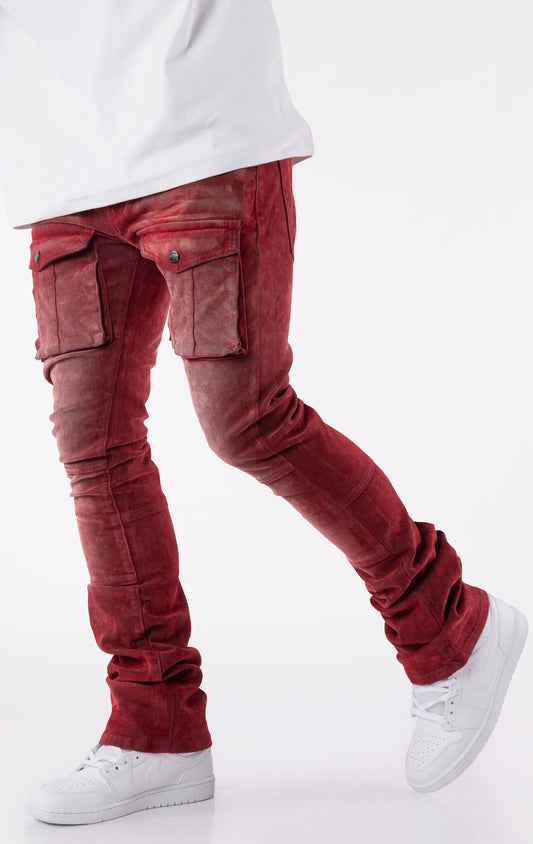 Red velour-coated stacked jeans with oversized cargo pockets, showcasing a soft texture, button closures, and extended length for a stacked ankle look.