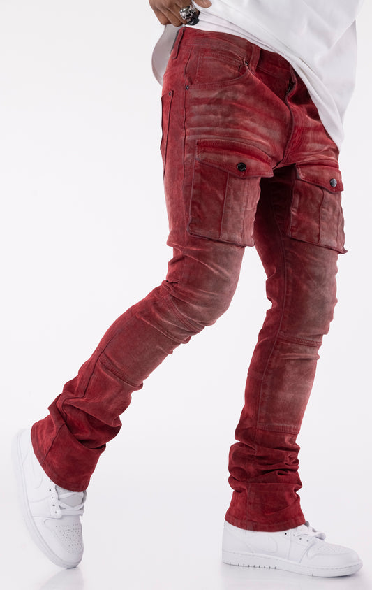 Red velour-coated stacked jeans with oversized cargo pockets, showcasing a soft texture, button closures, and extended length for a stacked ankle look.