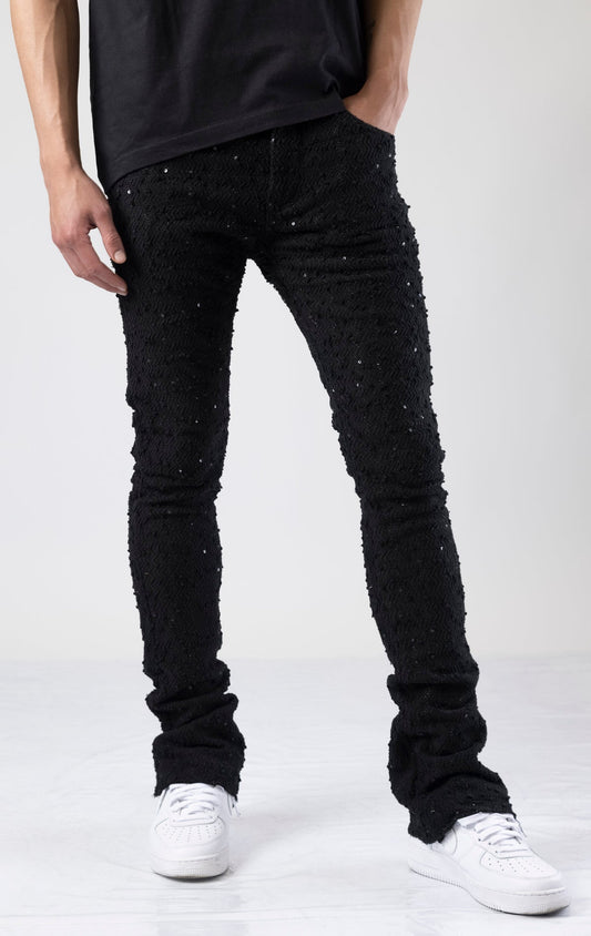 Black embellished stacked flared jeans in black.