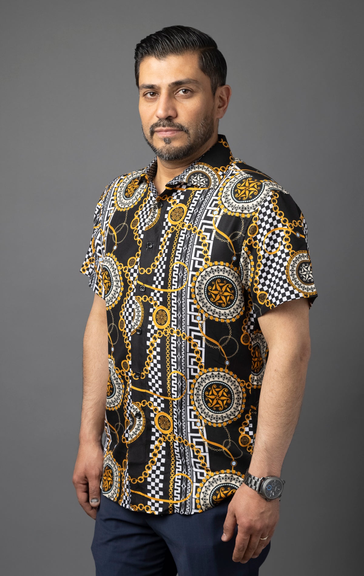 Black button up shirt with an all-over print featuring a bold, antique tile chain motif.