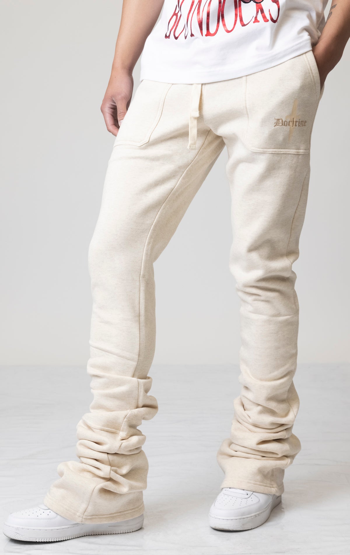 Oatmeal Core Dagger Super Stacked Joggers feature a unique, stacked leg design for a stylish look. Subtle embroidered branding adds a touch of detail. The joggers are made from a comfortable blend of 80% cotton and 20% polyester for all-day wear. An elastic waistband and pockets offer both convenience and functionality.