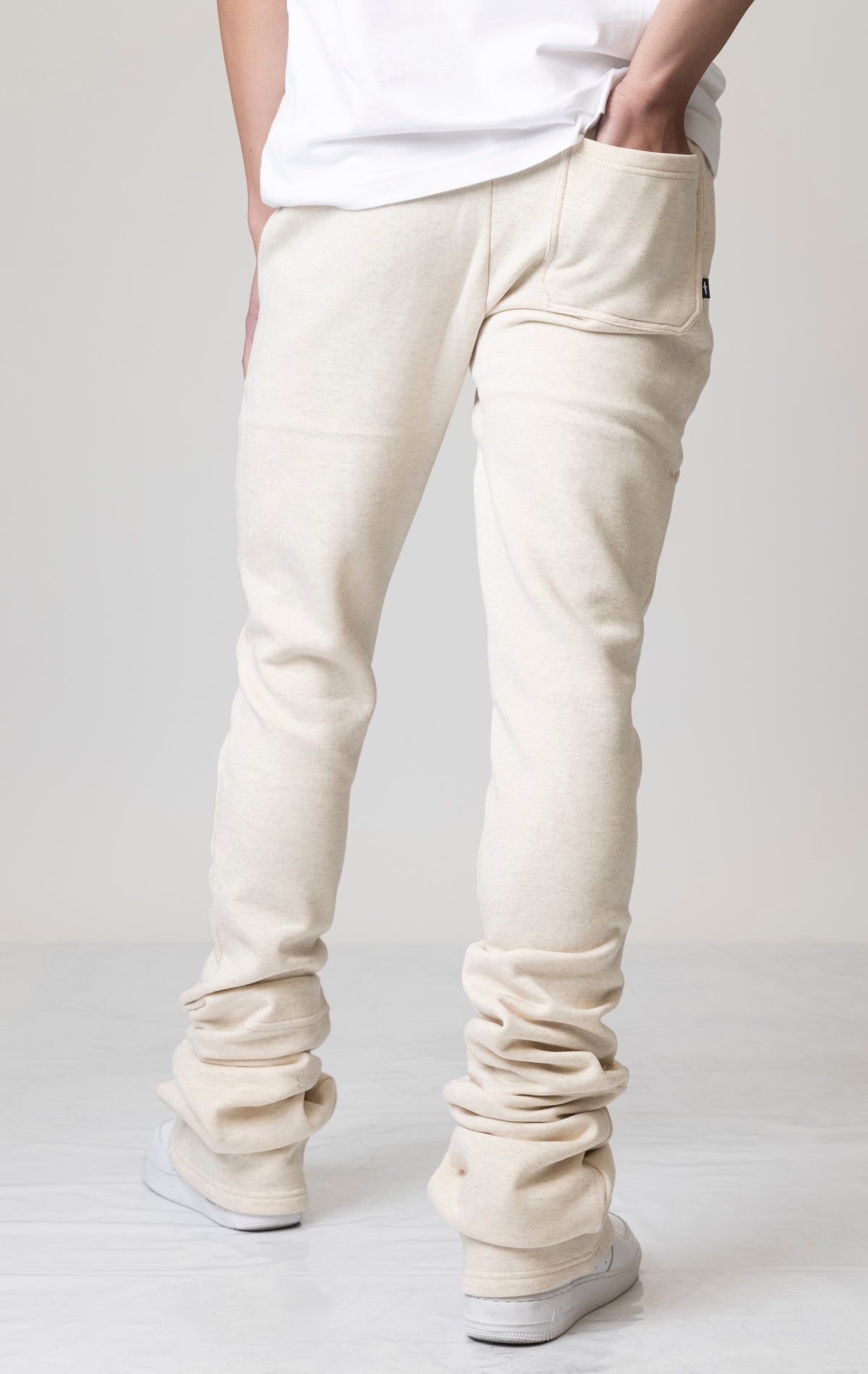 Oatmeal Core Dagger Super Stacked Joggers feature a unique, stacked leg design for a stylish look. Subtle embroidered branding adds a touch of detail. The joggers are made from a comfortable blend of 80% cotton and 20% polyester for all-day wear. An elastic waistband and pockets offer both convenience and functionality.