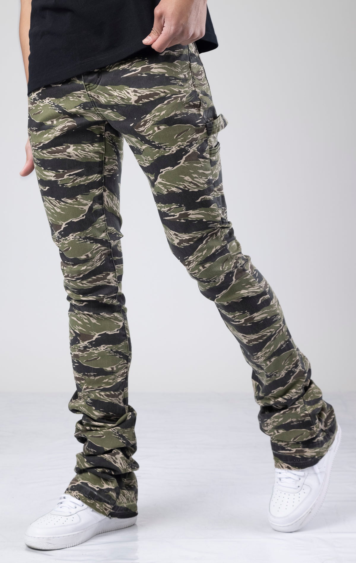 These jeans have a wide leg that dramatically flares out from the knee for a modern silhouette with a fashion-forward twist inspired by classic military aesthetics. They are made from a comfortable and durable, dark wash, cotton blend denim with stretch for all-day comfort. The jeans have functional front and back pockets, belt loops for adding a belt, and a signature patch on the back.