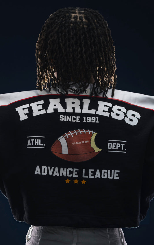 Black fleece crop top with dropped shoulders, double drawstrings, and screen print details. Made from 90% cotton and 10% polyester.