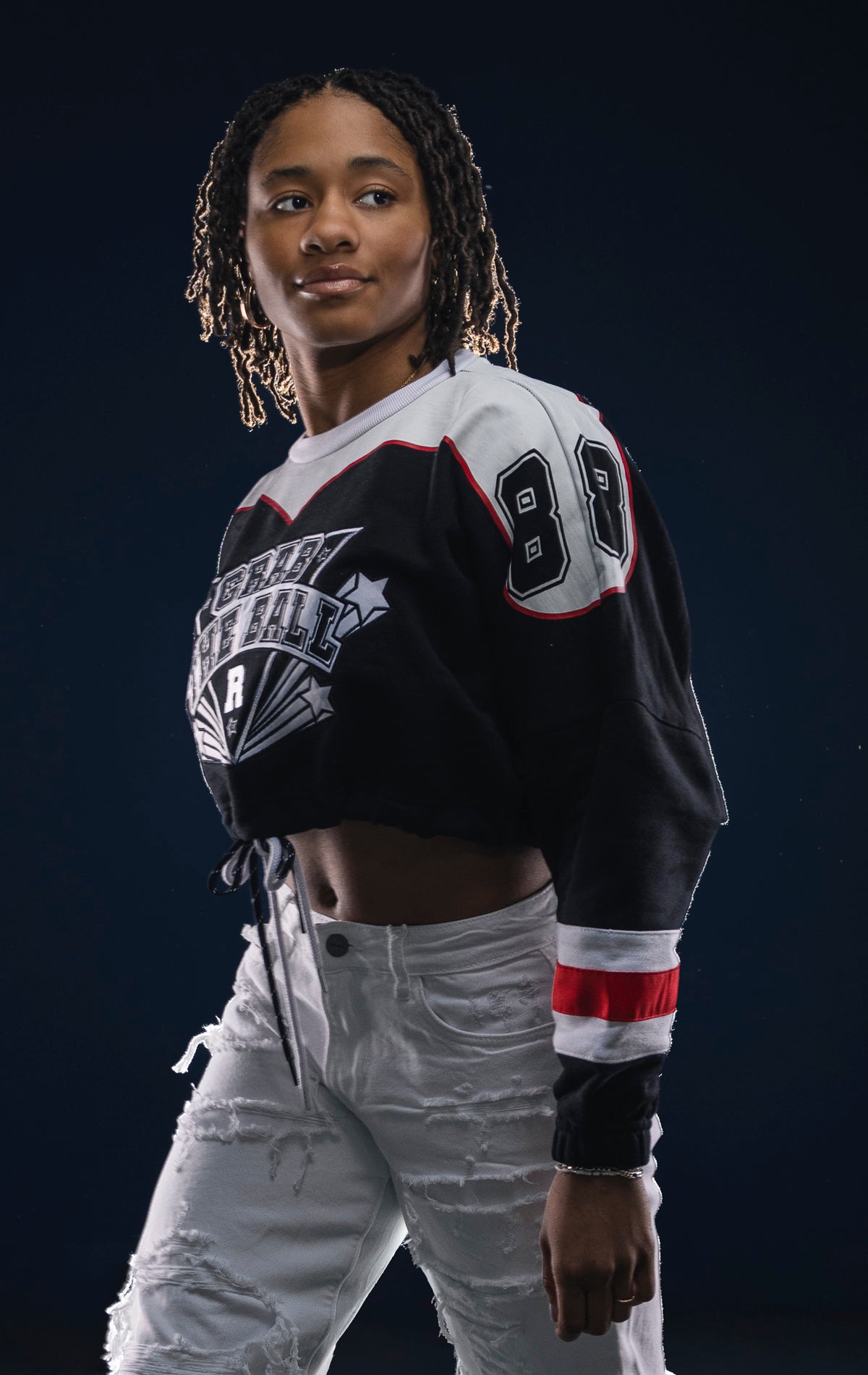 Black fleece crop top with dropped shoulders, double drawstrings, and screen print details. Made from 90% cotton and 10% polyester.Black clover dropped shoulder crop top with double drawstrings and screen printed details.