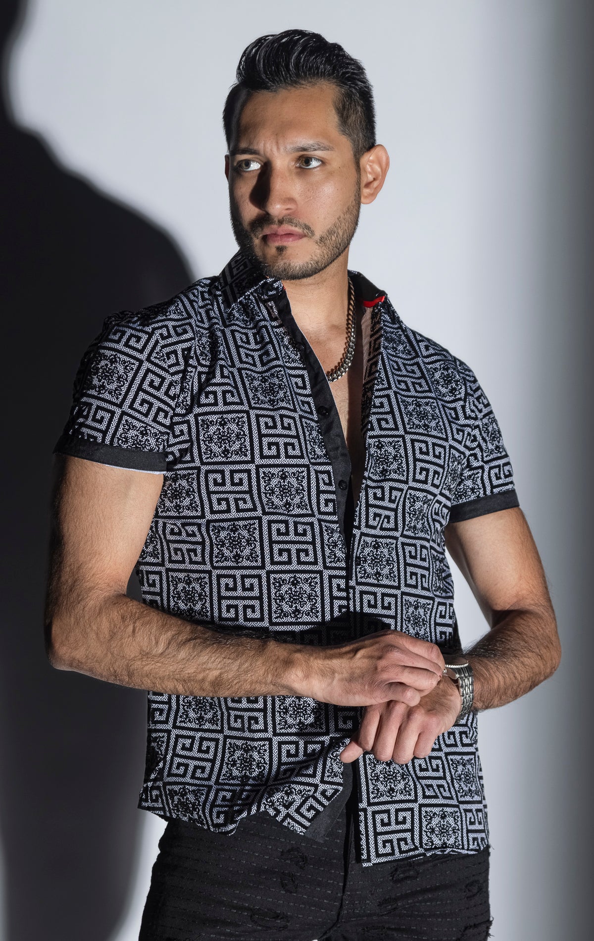 Men's casual, relaxed-fit button-down shirt with a short sleeve design. The shirt features an all-over Greek key pattern and a front button closure.