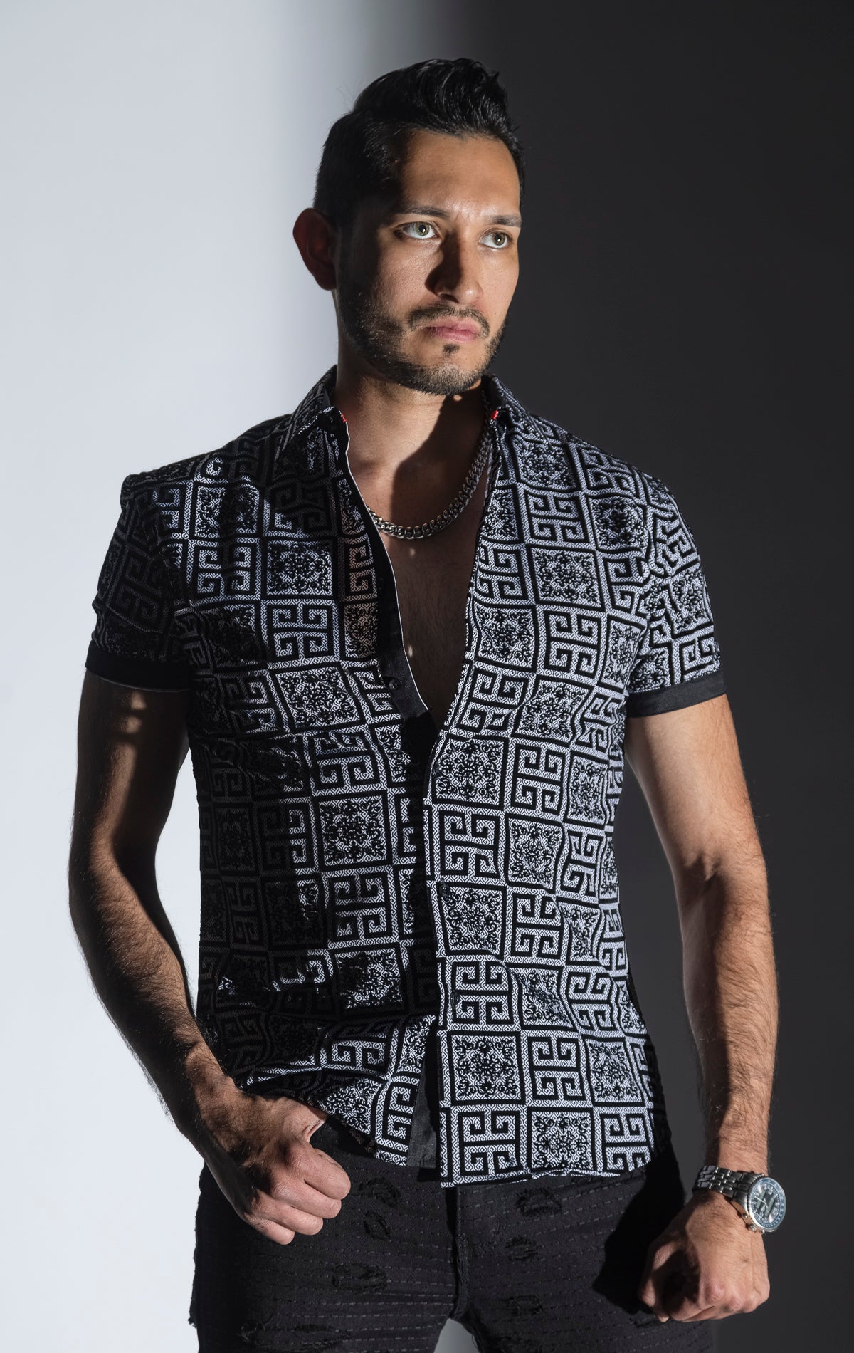 Men's casual, relaxed-fit button-down shirt with a short sleeve design. The shirt features an all-over Greek key pattern and a front button closure.