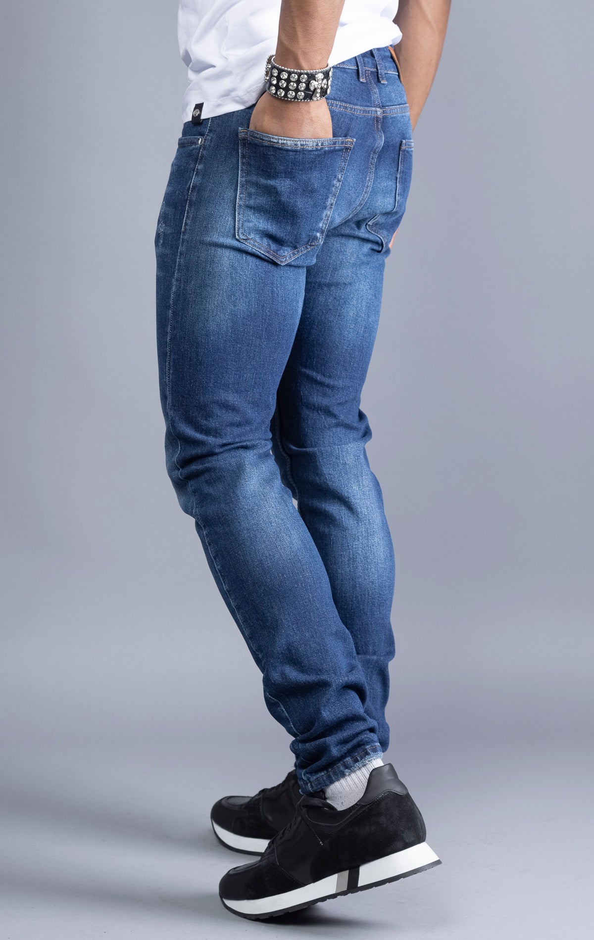 Dark blue slim-fit jeans with a narrow leg opening and five pockets.