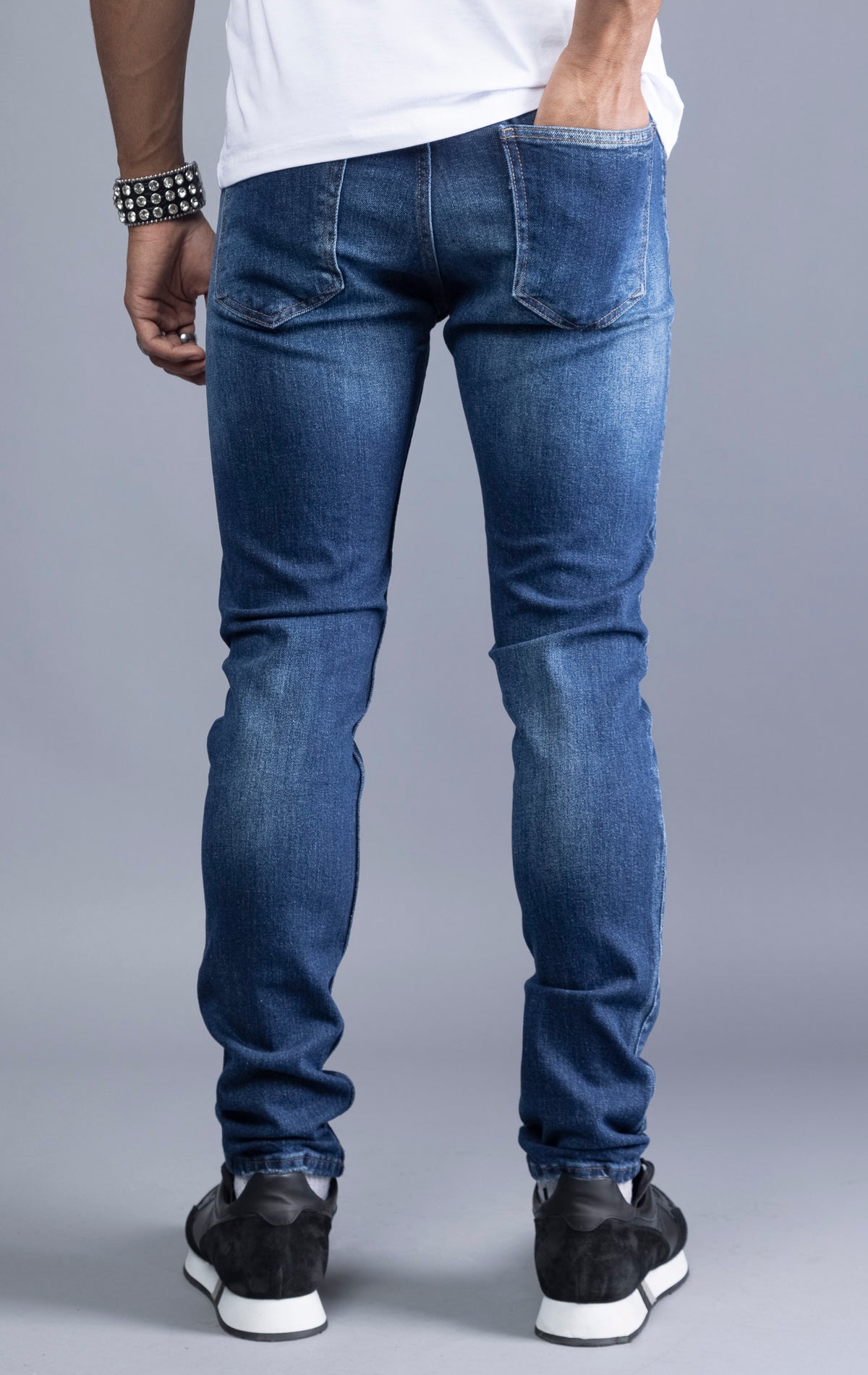 Dark blue slim-fit jeans with a narrow leg opening and five pockets.