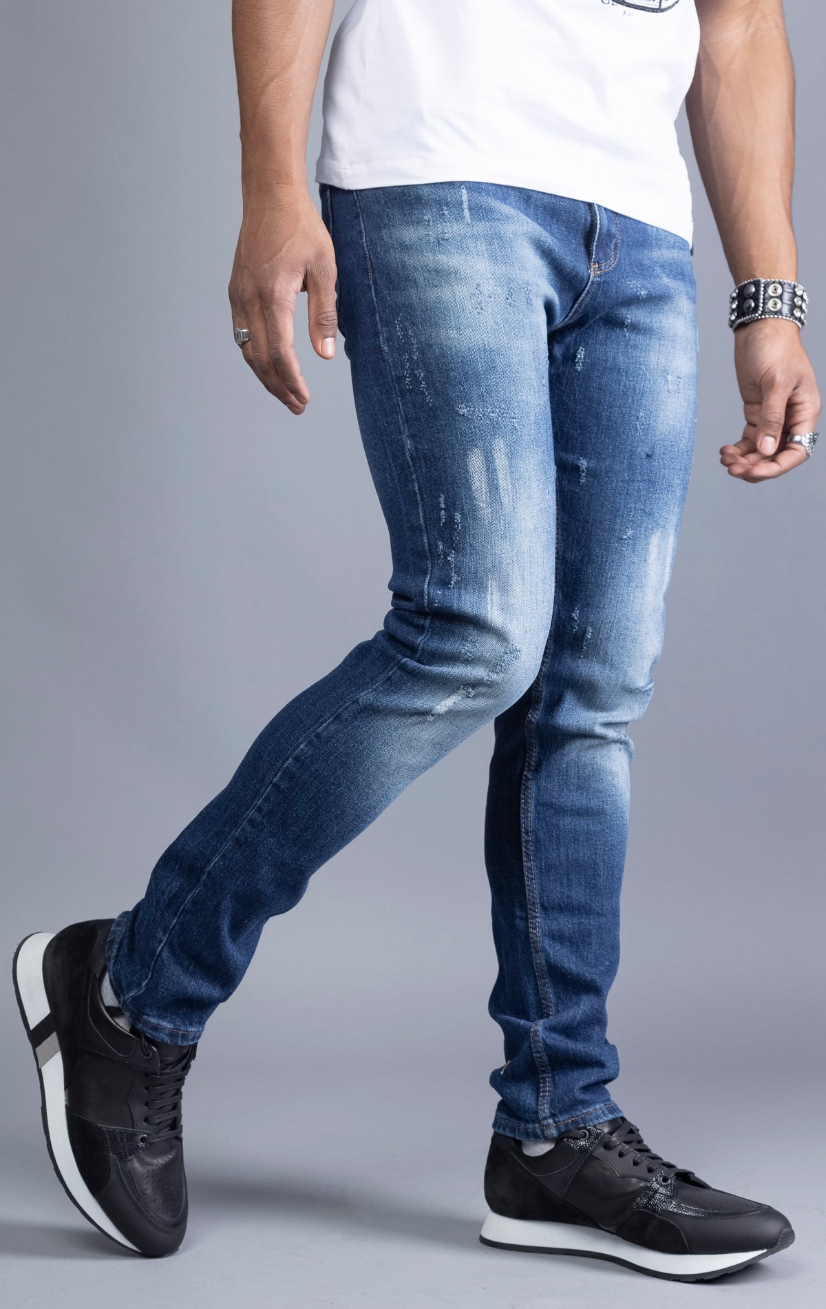 Blue slim-fit jeans with a narrow leg opening and five pockets.