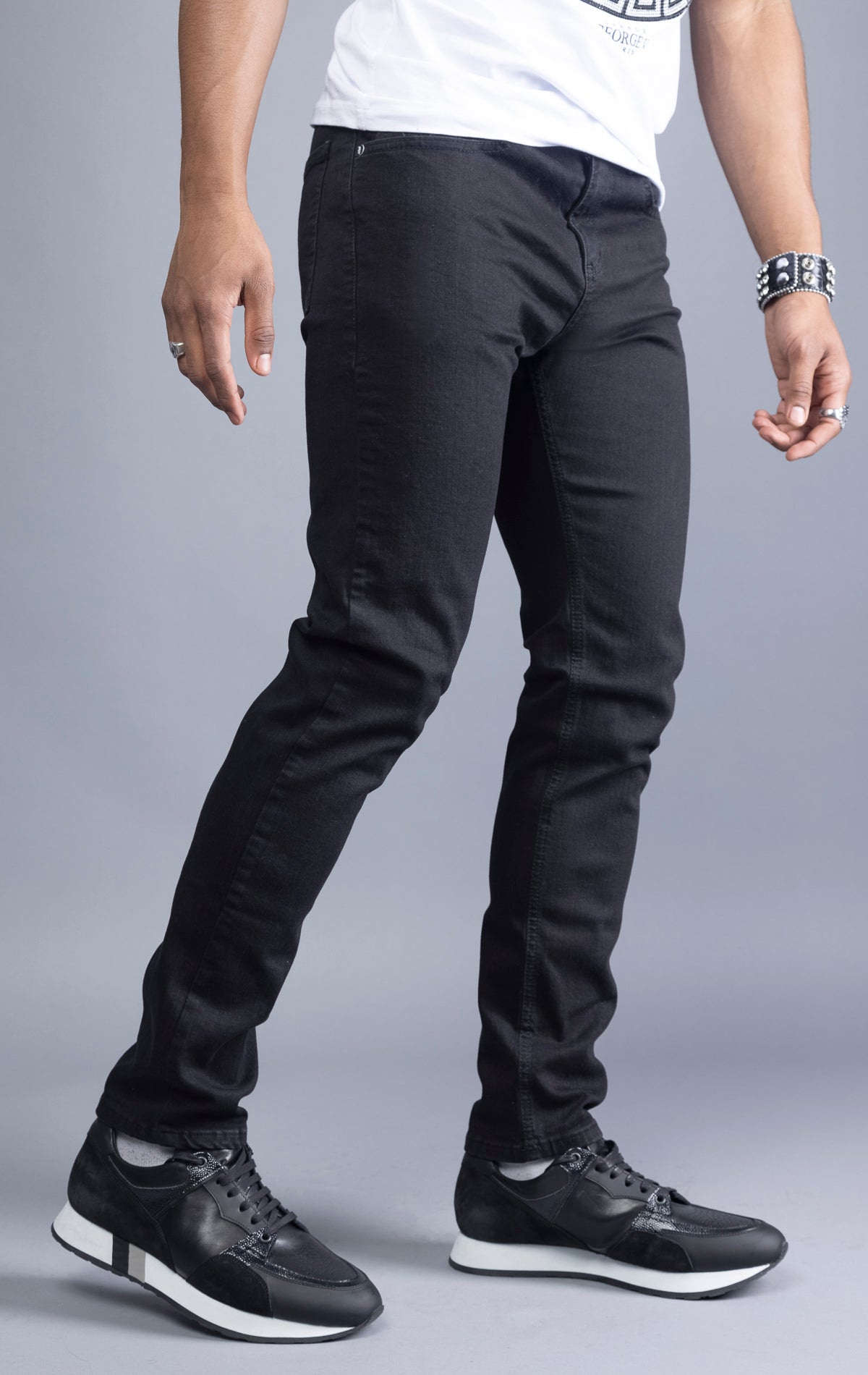 Black slim-fit jeans with a narrow leg opening and five pockets.