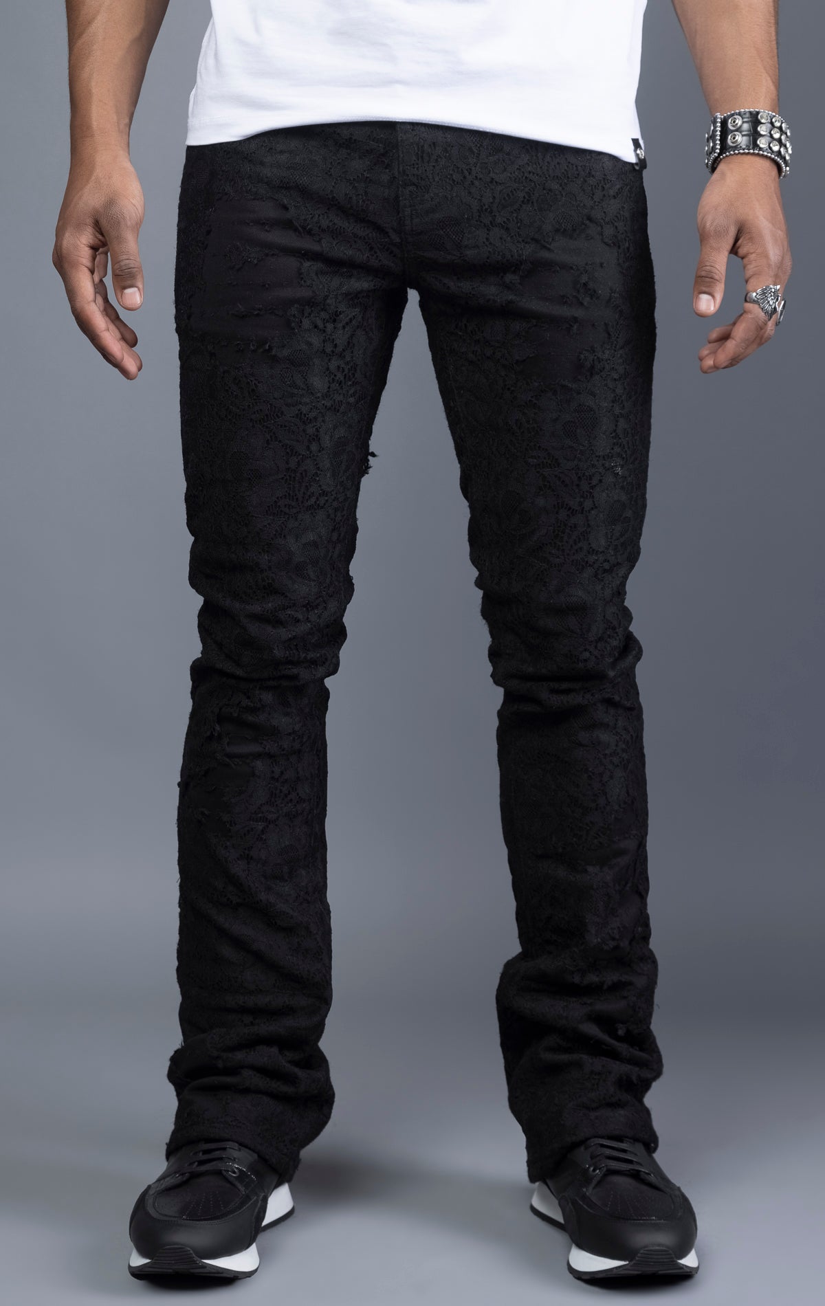 Mid-rise lace stacked leg jeans with a five-pocket design, belt loops, and zipper fly with top button fastening.