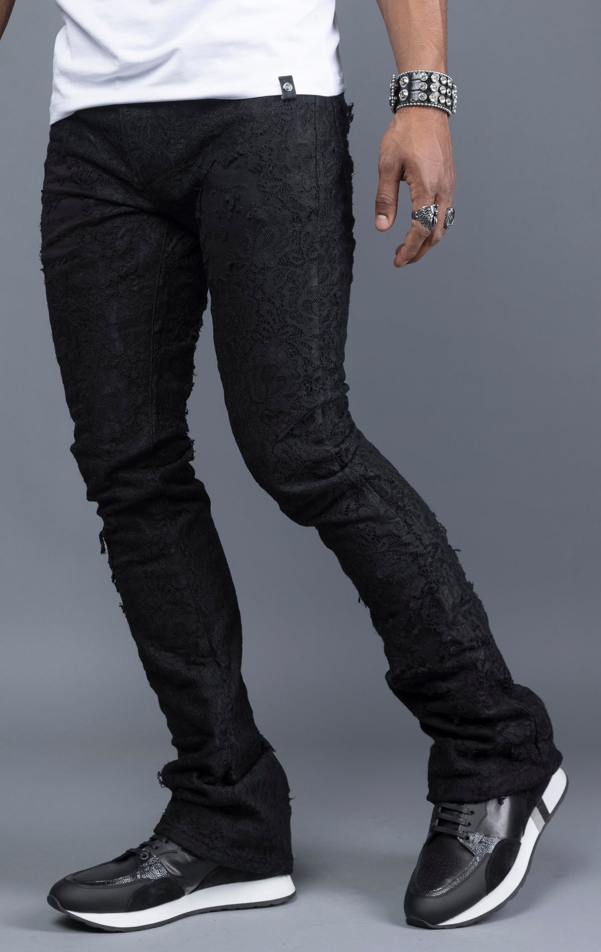 Mid-rise lace stacked leg jeans with a five-pocket design, belt loops, and zipper fly with top button fastening.