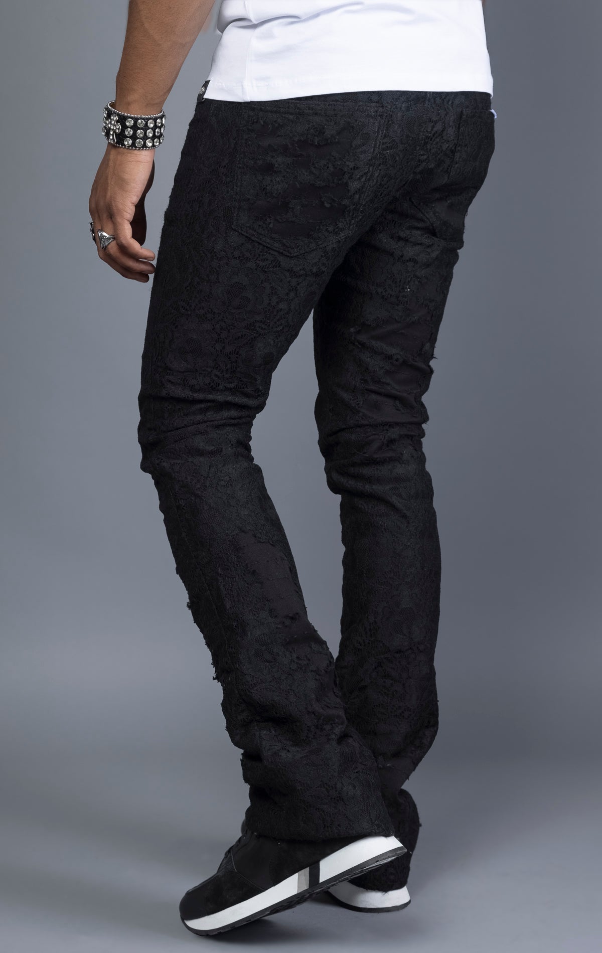 Mid-rise lace stacked leg jeans with a five-pocket design, belt loops, and zipper fly with top button fastening.