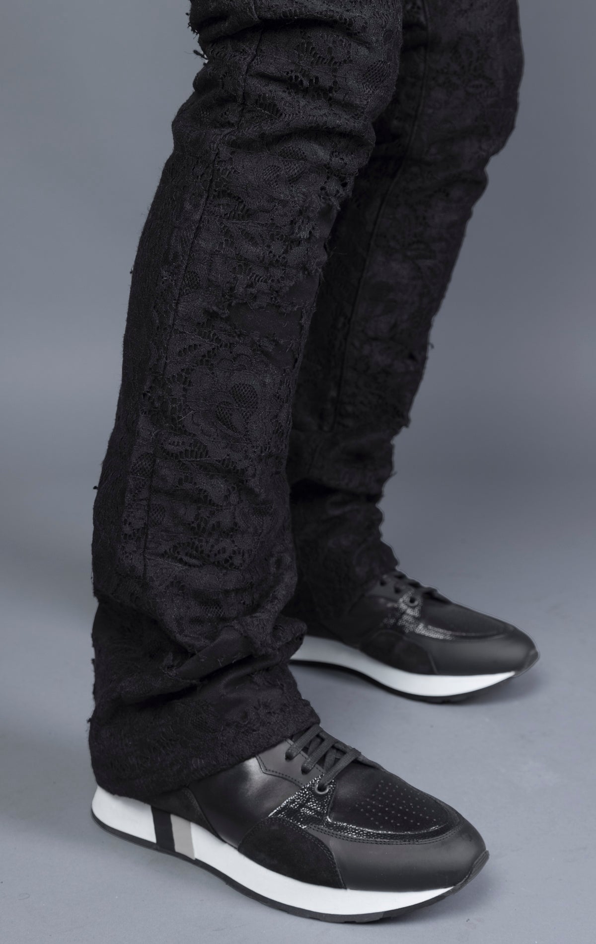 Mid-rise lace stacked leg jeans with a five-pocket design, belt loops, and zipper fly with top button fastening.