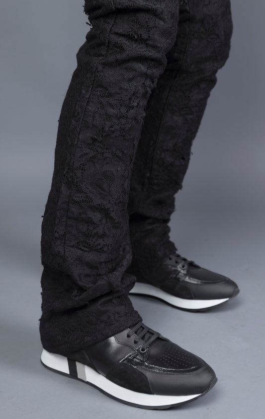 Mid-rise lace stacked leg jeans with a five-pocket design, belt loops, and zipper fly with top button fastening.