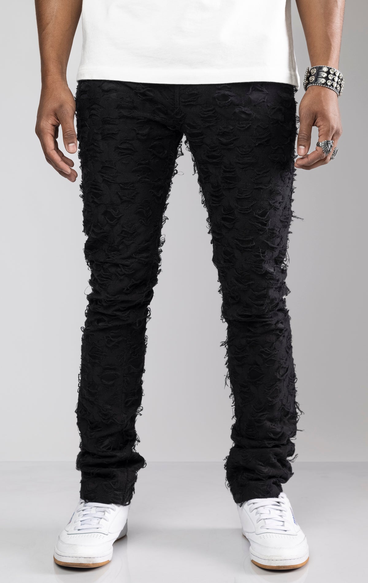 Stacked skinny pants in stretch twill with a ripped netting design throughout for a distressed look.