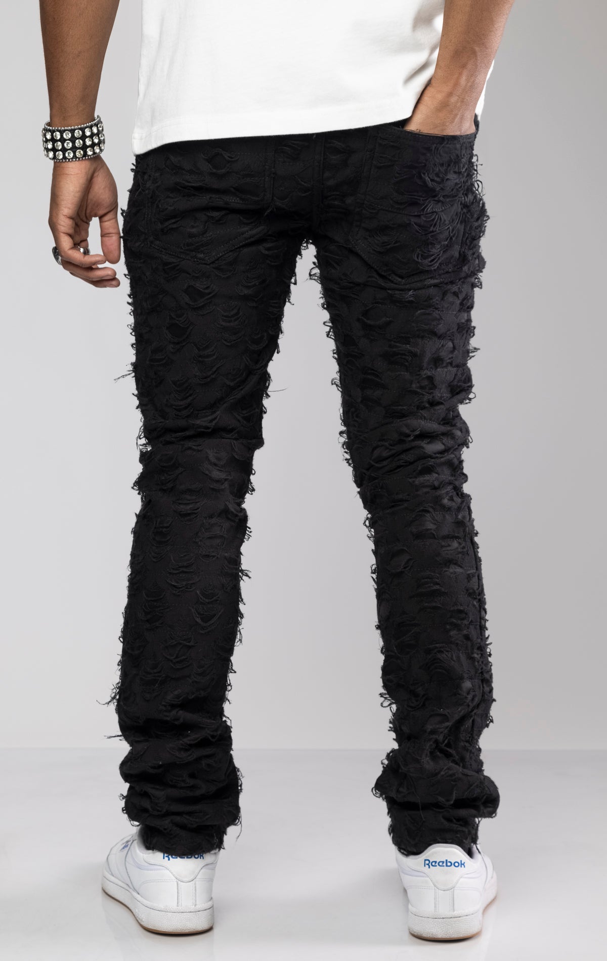 Stacked skinny pants in stretch twill with a ripped netting design throughout for a distressed look.