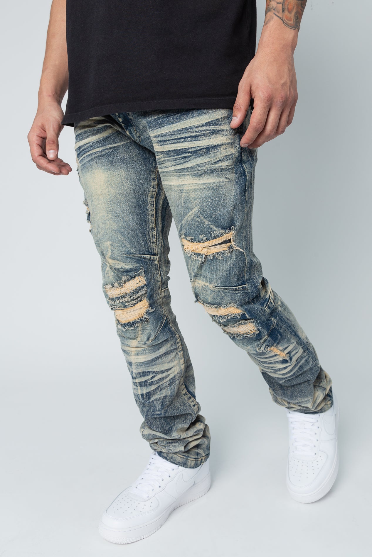 Light tint Washed up slim fit denim jeans, rip and repair style.
