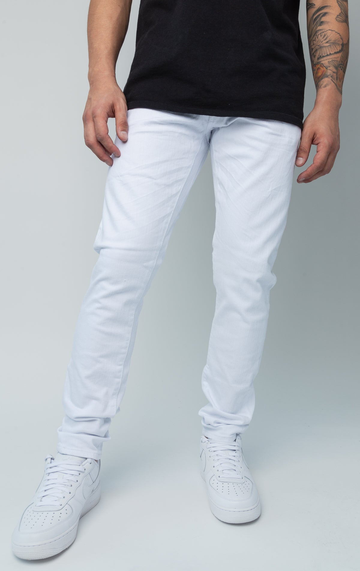 White skinny ankle jeans. Made from a comfortable 98% cotton and 2% lycra blend. Features a regular rise, a skinny fit that tapers from the knee to the ankle, hand-formed 3D wrinkles, a clean design with no rips or shreds, slub twill fabric, intricate detailing, and deep front pockets.