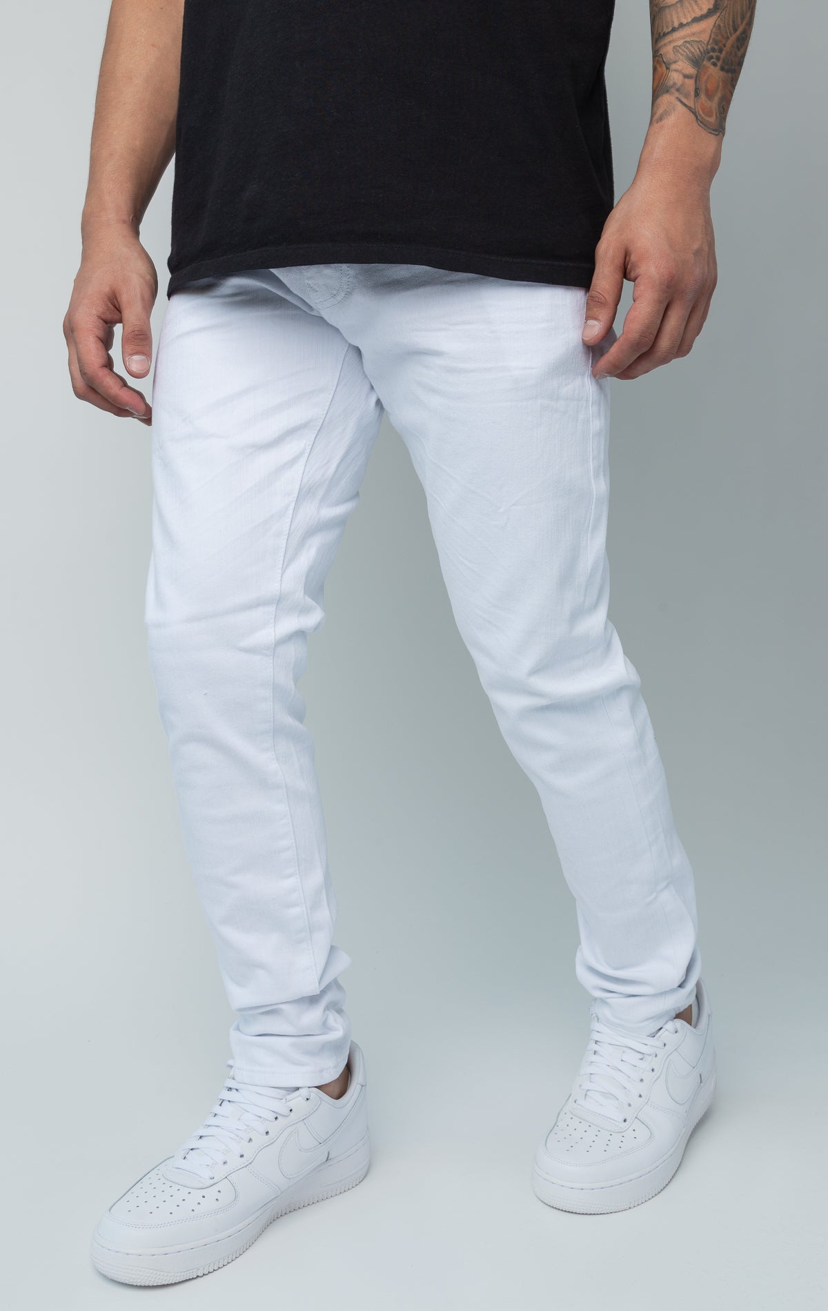 White skinny ankle jeans. Made from a comfortable 98% cotton and 2% lycra blend. Features a regular rise, a skinny fit that tapers from the knee to the ankle, hand-formed 3D wrinkles, a clean design with no rips or shreds, slub twill fabric, intricate detailing, and deep front pockets.