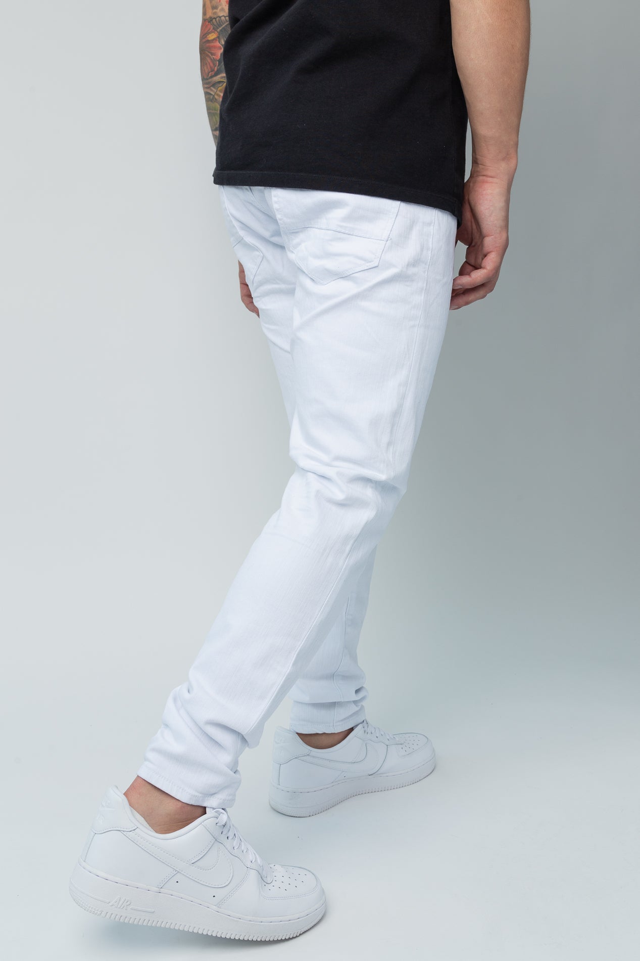 White skinny ankle jeans. Made from a comfortable 98% cotton and 2% lycra blend. Features a regular rise, a skinny fit that tapers from the knee to the ankle, hand-formed 3D wrinkles, a clean design with no rips or shreds, slub twill fabric, intricate detailing, and deep front pockets.