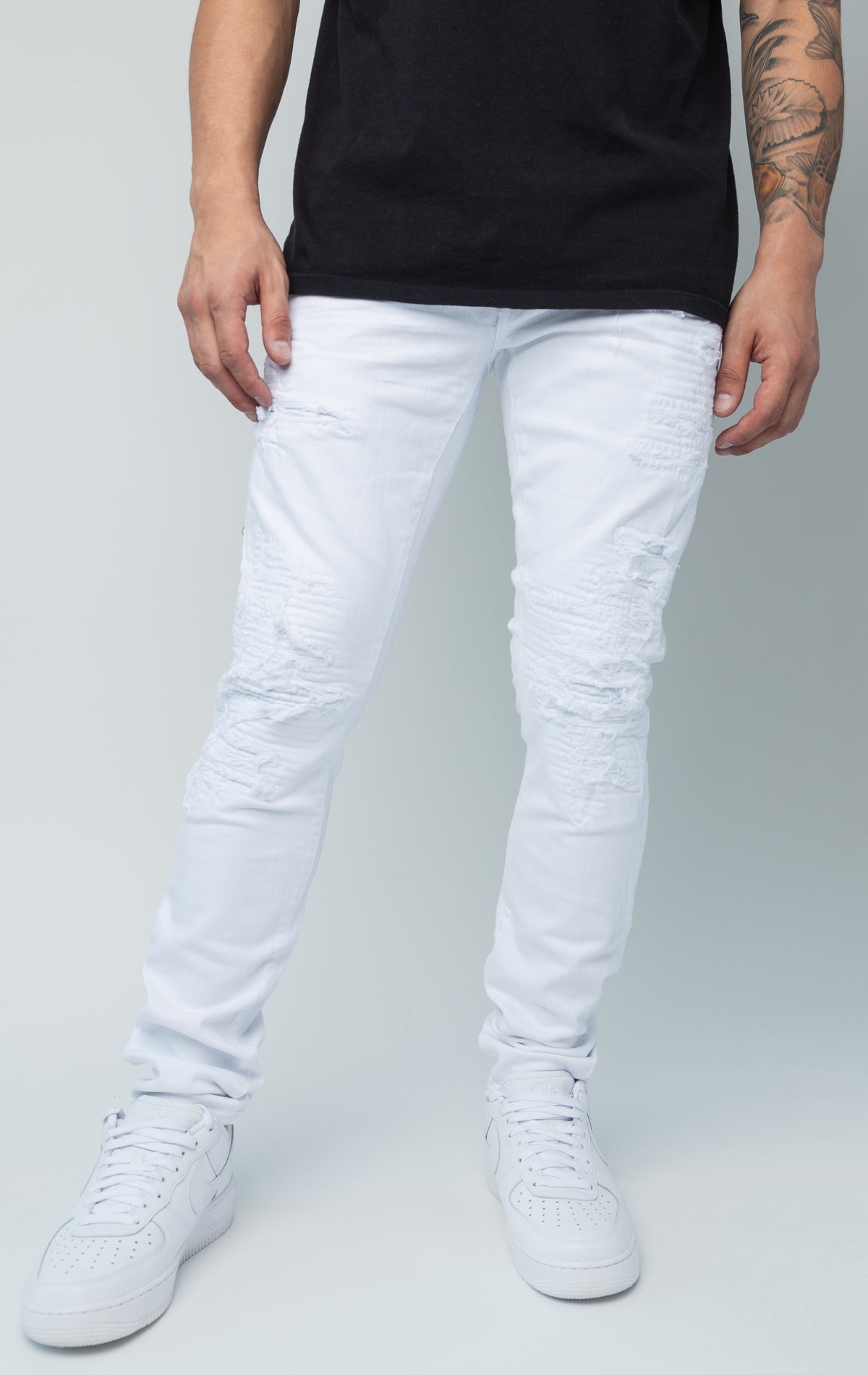 White skinny jeans. Made from a comfortable 98% cotton and 2% lycra blend. Features a regular rise, a tight fit that tapers from the knee to the ankle, hand-formed 3D wrinkles, ripped and repaired design with self-fabric backing, repair stitching, slub twill fabric, intricate detailing, and deep front pockets.