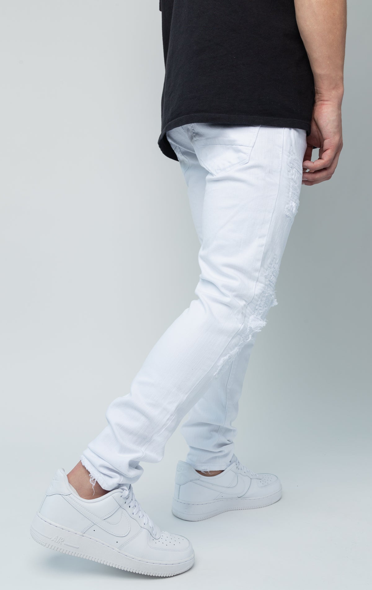 White skinny jeans. Made from a comfortable 98% cotton and 2% lycra blend. Features a regular rise, a tight fit that tapers from the knee to the ankle, hand-formed 3D wrinkles, ripped and repaired design with self-fabric backing, repair stitching, slub twill fabric, intricate detailing, and deep front pockets.