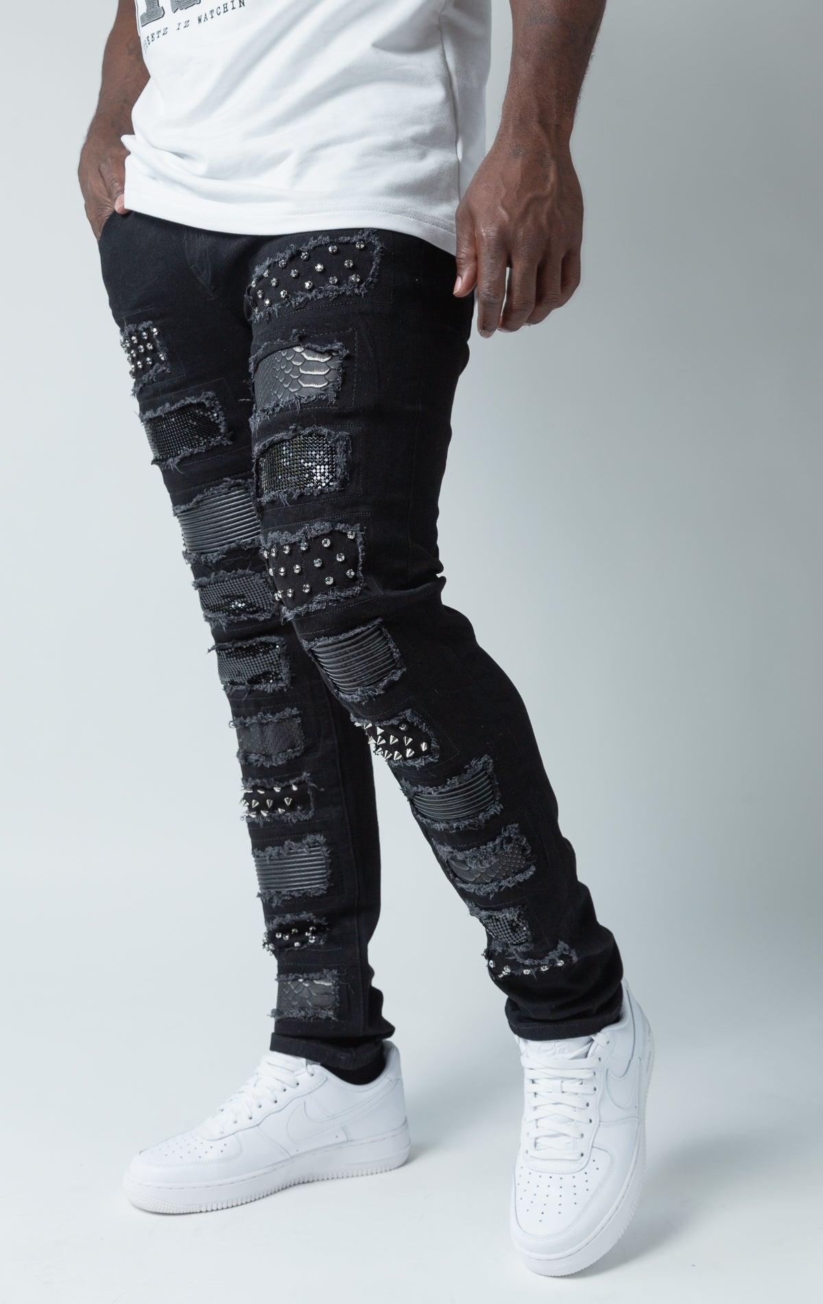 Black distressed denim jeans with rhinestones and studs