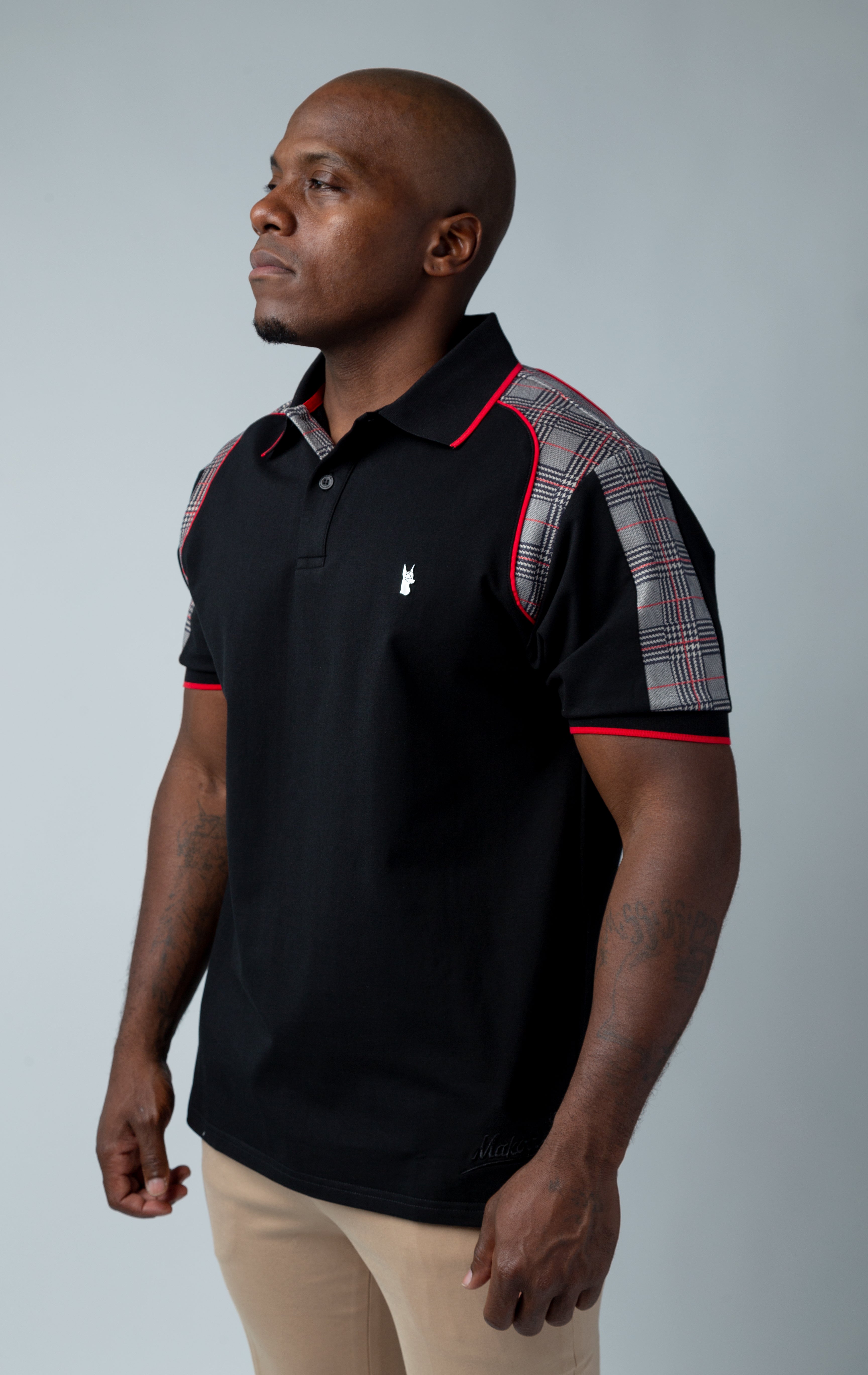 Black Polo shirt featuring a distinctive plaid yoke