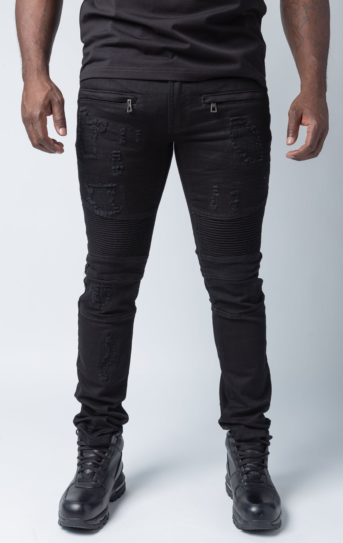 Black pants with rip and repair design and slim fit